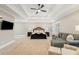 A comfortable main bedroom is bathed in natural light with tray ceiling and ceiling fan at 2377 Kesgrove Way, Buford, GA 30518