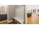 Mudroom with built-in bench and coat hooks, next to a powder room at 2377 Kesgrove Way, Buford, GA 30518