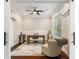 Well-lit office with dark wood floors, ceiling fan, a desk and barn door at 2377 Kesgrove Way, Buford, GA 30518