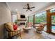 Cozy screened porch with fireplace, comfortable seating, and views of the pool and lush greenery at 2377 Kesgrove Way, Buford, GA 30518