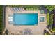 Aerial view showcases a modern pool with a built-in spa, lounge area, and meticulously designed brick patio at 2377 Kesgrove Way, Buford, GA 30518