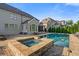 Luxury home featuring a beautiful pool and spa with stone accents, and lovely backyard patio at 2377 Kesgrove Way, Buford, GA 30518