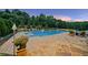 Outdoor oasis with a sparkling pool, manicured landscaping, and comfortable seating for ultimate relaxation at 2377 Kesgrove Way, Buford, GA 30518