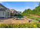 Backyard featuring a pool and stone spa surrounded by lush landscaping, on a sunny day at 2377 Kesgrove Way, Buford, GA 30518