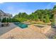 Backyard featuring a pool and spa, with lush landscaping and space for outdoor seating at 2377 Kesgrove Way, Buford, GA 30518