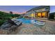 Stunning backyard pool with sun loungers and in-water tanning ledges perfect for relaxation and entertaining at 2377 Kesgrove Way, Buford, GA 30518