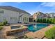 Luxury home featuring a beautiful pool and spa with stone accents, and lovely backyard patio at 2377 Kesgrove Way, Buford, GA 30518