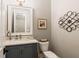 Charming powder room with grey vanity and stylish fixtures at 2377 Kesgrove Way, Buford, GA 30518