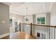 Beautiful staircase with hardwood floors, iron railing and natural light from surrounding windows at 2377 Kesgrove Way, Buford, GA 30518