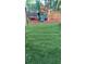 Backyard features a trampoline, playground, and bordered by a wooden fence at 340 Fountainmist Trl, Lawrenceville, GA 30043