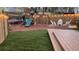 Backyard features a trampoline, playground, white chairs, and a wooden fence at 340 Fountainmist Trl, Lawrenceville, GA 30043