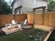 Backyard with a firepit, surrounded by chairs, and bordered by a wooden fence at 340 Fountainmist Trl, Lawrenceville, GA 30043
