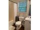 Bathroom featuring a standard toilet, shower/tub combo, and a large window at 340 Fountainmist Trl, Lawrenceville, GA 30043