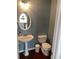Powder room featuring a pedestal sink, toilet, and a decorative mirror and a fresh coat of paint at 340 Fountainmist Trl, Lawrenceville, GA 30043
