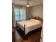 Bright bedroom with hardwood floors, a ceiling fan, and a large window with white curtains at 340 Fountainmist Trl, Lawrenceville, GA 30043