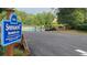 Community pool sign with a parking lot and trees in the background at 340 Fountainmist Trl, Lawrenceville, GA 30043