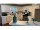 Updated kitchen featuring white cabinetry, stainless steel appliances, and a breakfast bar for casual dining at 340 Fountainmist Trl, Lawrenceville, GA 30043