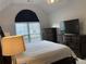Main bedroom with neutral walls, an arched window, and ample storage in matching dressers at 340 Fountainmist Trl, Lawrenceville, GA 30043