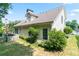 Back of home with a well-kept lawn, patio and grill, surrounded by mature trees at 5365 Twin Creeks Dr, Norcross, GA 30071