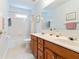 Bright bathroom featuring a double sink vanity and shower-tub combination at 5365 Twin Creeks Dr, Norcross, GA 30071