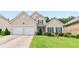 Charming two-story home featuring a well-manicured lawn and a two-car garage at 5365 Twin Creeks Dr, Norcross, GA 30071