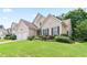 Inviting two-story home with lush landscaping and a green lawn at 5365 Twin Creeks Dr, Norcross, GA 30071