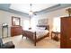Relaxing main bedroom features a tray ceiling, ceiling fan, and coordinated furnishings at 5365 Twin Creeks Dr, Norcross, GA 30071