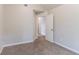 Bedroom features neutral walls, carpet, a window, closet, and open entry way at 5421 Salem Springs Dr, Lithonia, GA 30038