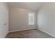 Neutral bedroom with plush carpeting, a window, and a closet; simple and inviting at 5421 Salem Springs Dr, Lithonia, GA 30038