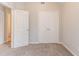 Bedroom features neutral walls, carpet, a window, and closet with double doors at 5421 Salem Springs Dr, Lithonia, GA 30038
