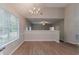 Bright dining area with wood floors, chandelier, and view into another room at 5421 Salem Springs Dr, Lithonia, GA 30038