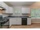 Functional kitchen with white cabinets, sleek countertops, and modern appliances, designed for easy meal preparation at 5421 Salem Springs Dr, Lithonia, GA 30038