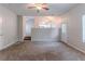 Open living area with plush carpeting, neutral paint, and a view to the kitchen and dining spaces at 5421 Salem Springs Dr, Lithonia, GA 30038