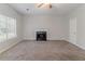 Bright living room features a traditional fireplace, plush carpeting, and a large window at 5421 Salem Springs Dr, Lithonia, GA 30038