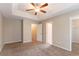 Spacious main bedroom with neutral carpet, a ceiling fan, and an en-suite bathroom at 5421 Salem Springs Dr, Lithonia, GA 30038