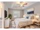 Serene main bedroom with a tray ceiling, soft lighting, and a cozy bed, providing a peaceful retreat at 5421 Salem Springs Dr, Lithonia, GA 30038