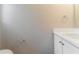 Functional powder room with a white vanity, sink, and essential fixtures at 5421 Salem Springs Dr, Lithonia, GA 30038