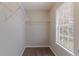 Walk-in closet with shelving, a window for natural light, and neutral carpeting at 5421 Salem Springs Dr, Lithonia, GA 30038