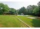 Expansive backyard with pool, gazebo, and wooden deck/play area at 1851 Harvest Way, Loganville, GA 30052