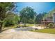Spacious backyard features a pool, mature trees, lounge area, and a tiered wooden deck at 1851 Harvest Way, Loganville, GA 30052