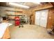 Unfinished basement with shelving, wood walls, and access to the backyard through a double door at 1851 Harvest Way, Loganville, GA 30052