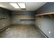 Unfinished basement area with painted gray walls, floating wood shelves and concrete floor at 1851 Harvest Way, Loganville, GA 30052