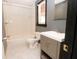 Bathroom features a shower-tub combo and vanity with gray cabinets and a single sink at 1851 Harvest Way, Loganville, GA 30052