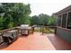The wooden deck features an outdoor cooking area with a stainless steel grill at 1851 Harvest Way, Loganville, GA 30052