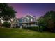 Charming two-story home with a well-manicured front yard and inviting covered porch at 1851 Harvest Way, Loganville, GA 30052