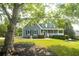 Lovely two-story home with a welcoming front porch and beautifully landscaped front yard at 1851 Harvest Way, Loganville, GA 30052