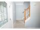 Entry hall featuring a staircase with wood handrail and white spindles near a decorative glass door at 1851 Harvest Way, Loganville, GA 30052