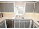 Bright kitchen with gray cabinets, undermount sink and stainless steel appliances, creating a functional and stylish cooking space at 1851 Harvest Way, Loganville, GA 30052