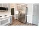 Modern kitchen featuring gray cabinetry, a stainless steel refrigerator, and a complementing countertop, perfect for Gathering meals at 1851 Harvest Way, Loganville, GA 30052