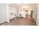 Open concept kitchen with gray cabinets and stainless steel appliances flowing into dining area at 1851 Harvest Way, Loganville, GA 30052